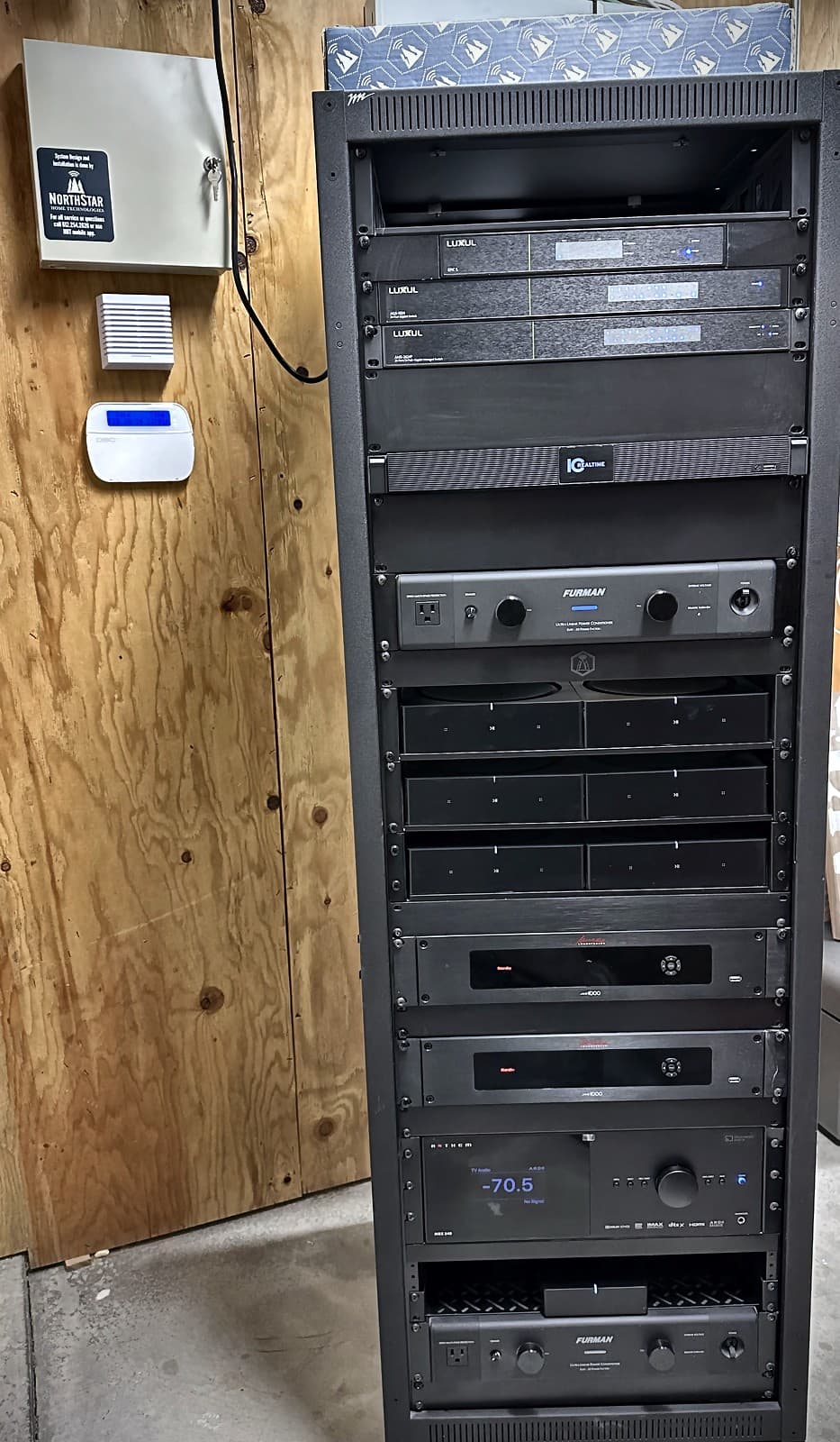 Professional home networking equipment rack with structured wiring and enterprise components