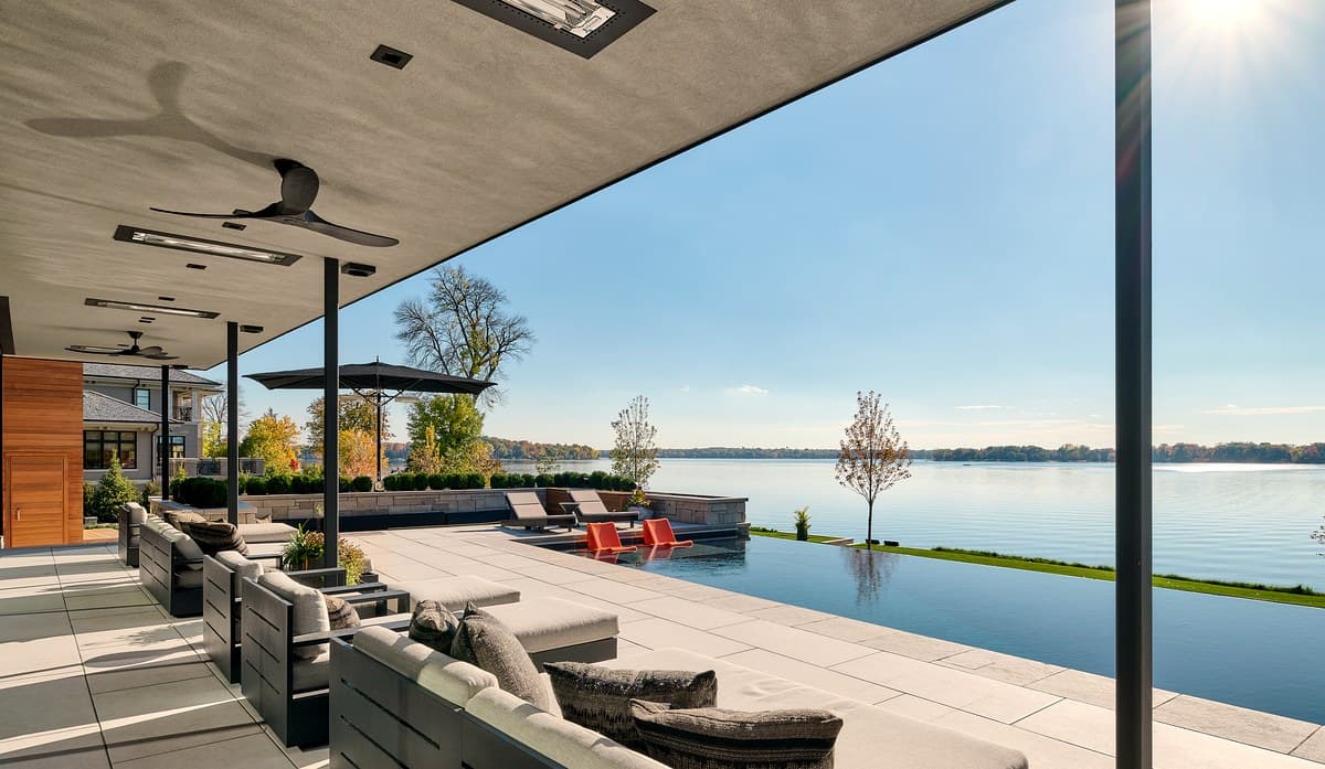 Lakefront pool patio with outdoor speakers and integrated audio